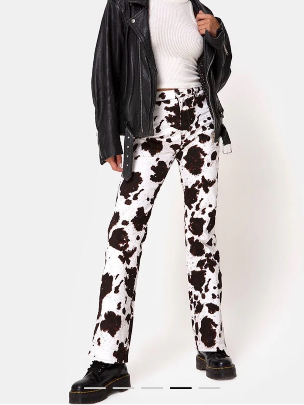 Motel Rocks cow print pants with a slightly flared leg silhouette.